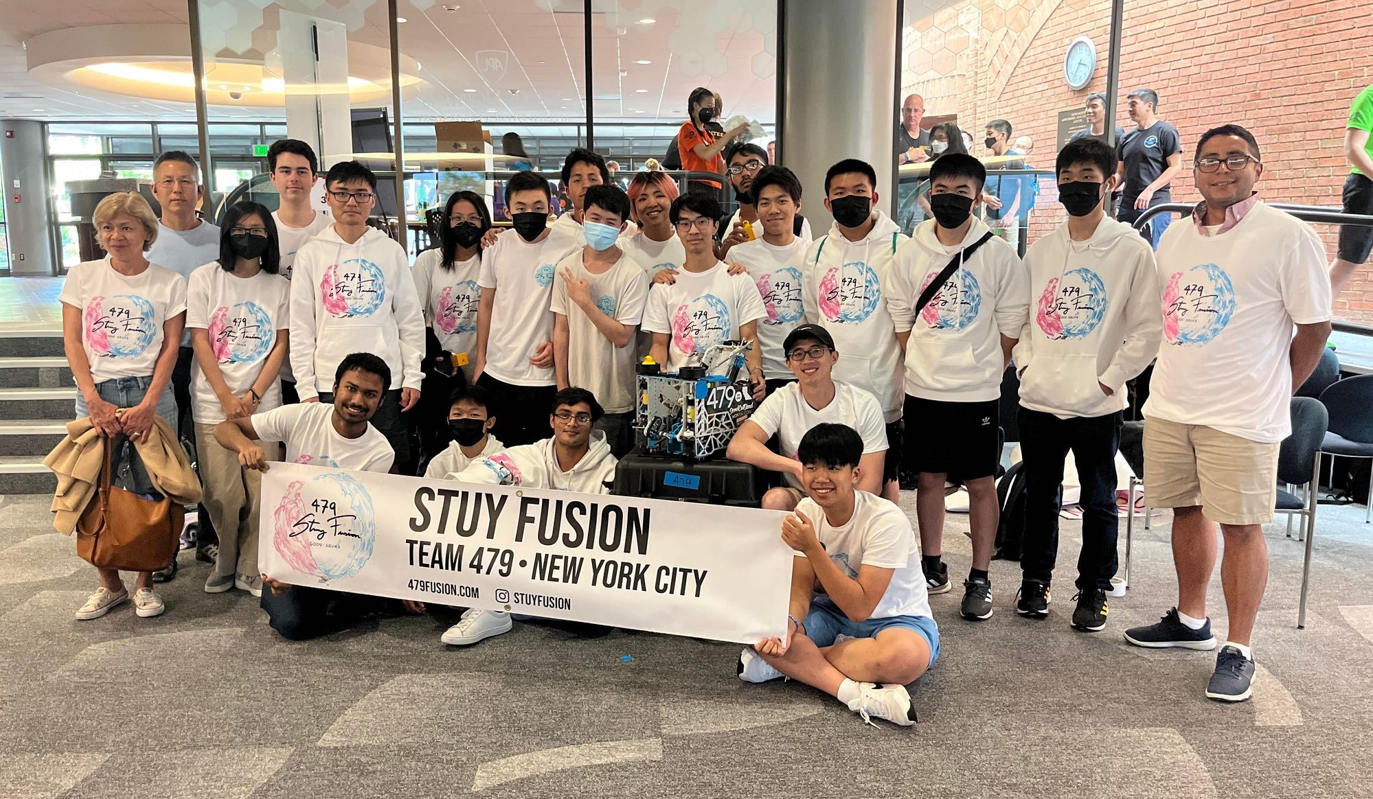Image: a photo of team 479's members together holding up a banner